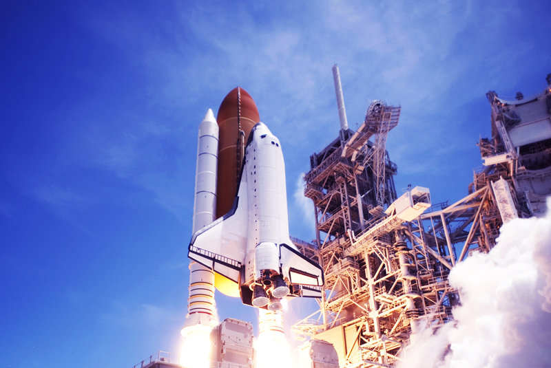 A space shuttle is taking off from the launch pad.